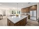 Open concept kitchen with large island, stainless steel appliances, and adjacent dining area at 2743 E Virginia St, Gilbert, AZ 85296