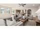 Open-concept living room with hardwood floors, neutral color scheme, and seamless flow to dining and kitchen at 2743 E Virginia St, Gilbert, AZ 85296
