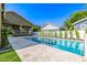 Backyard featuring a sparkling pool with stone patio and well-maintained landscaping at 2743 E Virginia St, Gilbert, AZ 85296