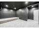 A cozy theater room with carpeted floor, gray walls, and elevated seating platform at 2743 E Virginia St, Gilbert, AZ 85296
