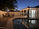 Pool and patio with black metal fence surrounding a lounge area and dining space at 2753 E Aster Dr, Phoenix, AZ 85032