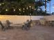 Backyard featuring a stone firepit, an outdoor kitchen and string lights at 2753 E Aster Dr, Phoenix, AZ 85032