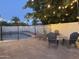 Backyard with a firepit, outdoor chairs, a pool and patio with string lights at 2753 E Aster Dr, Phoenix, AZ 85032