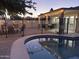 Backyard with black metal fence surrounding a pool and outdoor seating at 2753 E Aster Dr, Phoenix, AZ 85032
