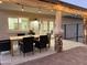 Outdoor dining area with stone columns and black wicker chairs at 2753 E Aster Dr, Phoenix, AZ 85032