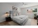 Neutral bedroom with a ceiling fan, hardwood floors, and large comfortable bed at 2753 E Aster Dr, Phoenix, AZ 85032