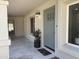 Inviting front porch with a sage door, decorative planter, and stone flooring at 2753 E Aster Dr, Phoenix, AZ 85032