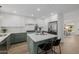 Modern kitchen featuring white and sage cabinetry, stainless steel appliances, and a spacious center island at 2753 E Aster Dr, Phoenix, AZ 85032