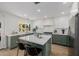 Well-lit kitchen with white upper cabinets, sage lower cabinets, stainless steel appliances, and marble countertops at 2753 E Aster Dr, Phoenix, AZ 85032