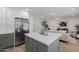 Kitchen island boasts a gorgeous white countertop and trendy green cabinets at 2753 E Aster Dr, Phoenix, AZ 85032