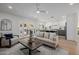 Bright open-concept living area features light hardwood floors and a ceiling fan at 2753 E Aster Dr, Phoenix, AZ 85032