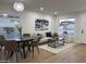 Open-concept living space, featuring dining area and living room with neutral tones and bright natural light at 2753 E Aster Dr, Phoenix, AZ 85032