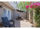 Enclosed backyard with chairs, picnic table and flowers at 2818 E Clarendon Ave, Phoenix, AZ 85016