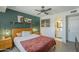 This bedroom features a ceiling fan and a cozy decor with a view to the bathroom at 2818 E Clarendon Ave, Phoenix, AZ 85016