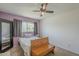 This bedroom features a ceiling fan, carpeted floors, and a window at 2818 E Clarendon Ave, Phoenix, AZ 85016