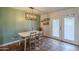 Charming dining room with light fixture, seating for four, and french doors to the outdoors at 2818 E Clarendon Ave, Phoenix, AZ 85016