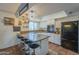 Eat-in kitchen with granite countertops, bar stool seating, updated appliances and lighting fixtures at 2818 E Clarendon Ave, Phoenix, AZ 85016