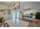 Open kitchen and dining area with island seating, modern appliances, and view to the backyard at 2818 E Clarendon Ave, Phoenix, AZ 85016