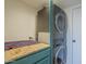 Practical laundry room featuring stacked washer and dryer with counter space, utility and storage at 2818 E Clarendon Ave, Phoenix, AZ 85016