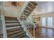 View of the home's carpeted staircase and dining area with light fixture and tiled floors at 2818 E Clarendon Ave, Phoenix, AZ 85016