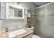 Bright bathroom features a granite vanity top, framed mirror, and tiled walk-in shower at 3109 W Loma Ln, Phoenix, AZ 85051