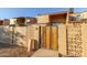 Exterior view of the home showcasing a private entrance with a decorative gate and stucco walls at 3646 N 67Th Ave # 29, Phoenix, AZ 85033
