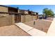 Side view of a row of townhouses, showing desert landscaping and gated entries at 3646 N 67Th Ave # 29, Phoenix, AZ 85033