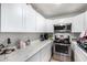 Bright kitchen features white cabinets, marble countertops, and stainless steel appliances at 3646 N 67Th Ave # 29, Phoenix, AZ 85033
