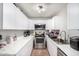 Efficient kitchen with white cabinets, stainless steel appliances, and marble countertops for a modern look at 3646 N 67Th Ave # 29, Phoenix, AZ 85033