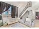 Inviting living room with stylish sofas, large windows, and a staircase leading to the upper level at 3646 N 67Th Ave # 29, Phoenix, AZ 85033