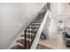 Carpeted staircase featuring wrought iron railing leading to the upper level at 3646 N 67Th Ave # 29, Phoenix, AZ 85033