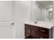 Bathroom featuring a cherry wood vanity with a white marble countertop and modern chrome fixtures at 36922 N Camarillo Dr, San Tan Valley, AZ 85140