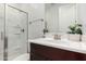 This bathroom features a glass shower door, a modern vanity, and a decorative plant, offering a clean and stylish space at 36922 N Camarillo Dr, San Tan Valley, AZ 85140