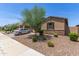 Charming single-story home with desert landscaping, a private front yard, and a two-car garage at 36922 N Camarillo Dr, San Tan Valley, AZ 85140