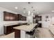 Bright kitchen featuring a large island with seating, modern pendant lights, and sleek cabinetry at 36922 N Camarillo Dr, San Tan Valley, AZ 85140