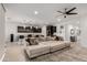 Bright open-concept living area featuring a large sectional sofa adjacent to the kitchen at 36922 N Camarillo Dr, San Tan Valley, AZ 85140