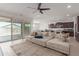 Open-concept living room with sliding glass doors, comfortable seating, and a seamless transition to the kitchen at 36922 N Camarillo Dr, San Tan Valley, AZ 85140