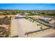 An aerial perspective of the expansive property showcasing its large lot, desert landscape and multi-vehicle garage at 38415 N 25Th Ave, Phoenix, AZ 85086