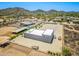 Aerial view of the property, showcasing the modern home and equestrian facilities at 38415 N 25Th Ave, Phoenix, AZ 85086
