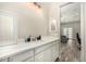 Bright bathroom featuring modern vanity, white cabinets, updated fixtures and wood-look floors at 38415 N 25Th Ave, Phoenix, AZ 85086