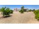Front yard with three-car garage, desert landscaping, and some trees at 38415 N 25Th Ave, Phoenix, AZ 85086