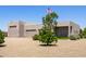 Front yard with desert landscaping and a three-car garage at 38415 N 25Th Ave, Phoenix, AZ 85086