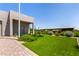 Well-manicured front yard with lush lawn, plants, and a walkway leading to a modern home at 38415 N 25Th Ave, Phoenix, AZ 85086