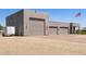 A detached three-car garage with desert landscaping and a trailer on a sunny day at 38415 N 25Th Ave, Phoenix, AZ 85086
