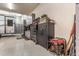 Expansive garage featuring gray cabinets, a workbench, tools, and a safe for secured storage at 38415 N 25Th Ave, Phoenix, AZ 85086