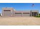 A detached three-car garage with desert landscaping on a sunny day at 38415 N 25Th Ave, Phoenix, AZ 85086
