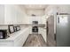 Bright kitchen with stainless steel appliances, modern cabinetry, and wood-look tile flooring at 38415 N 25Th Ave, Phoenix, AZ 85086