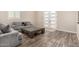 Comfortable living room with modern tile flooring, gray couches, and bright natural light at 38415 N 25Th Ave, Phoenix, AZ 85086