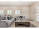 Inviting living room features two gray couches, wood-look tile flooring and white shuttered windows at 38415 N 25Th Ave, Phoenix, AZ 85086