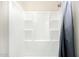 Clean shower features a shower curtain and built-in shelving at 38415 N 25Th Ave, Phoenix, AZ 85086